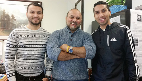 About Our Agency - Ramiro Martinez-Anillo Smiling and Standing Next to Two Other Young Men